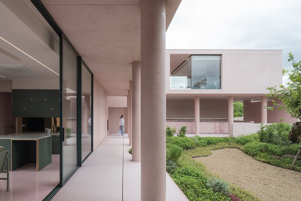 Minimalist architecture with glass walls, landscaped courtyard, and modern furnishings.