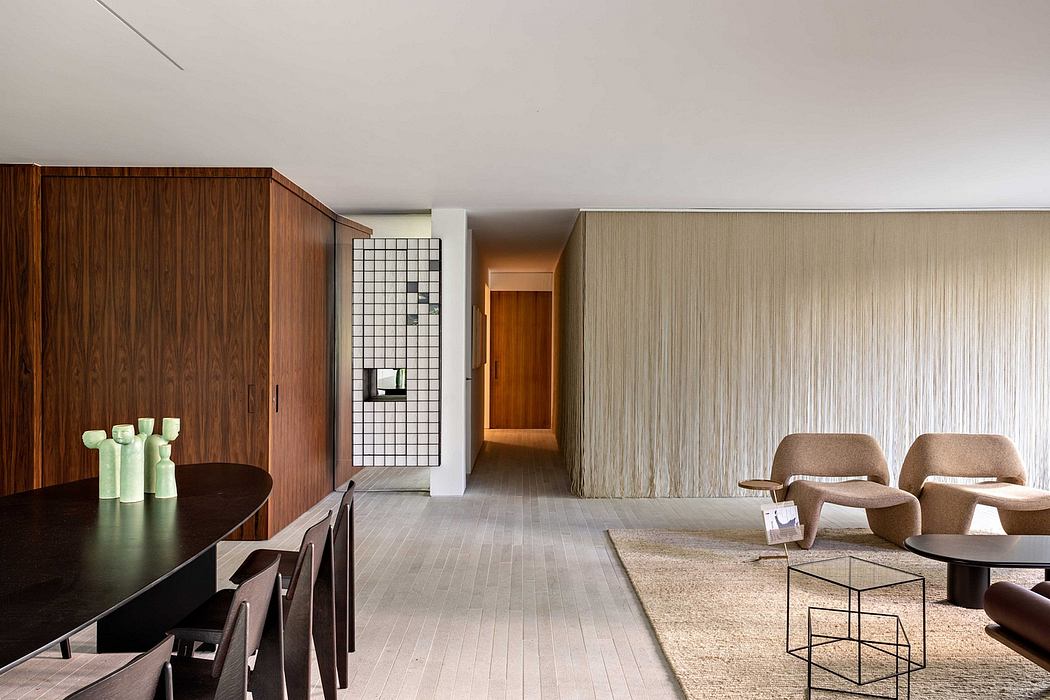 Minimalist modern interior with warm wood paneling, geometric tiled wall, and neutral seating.