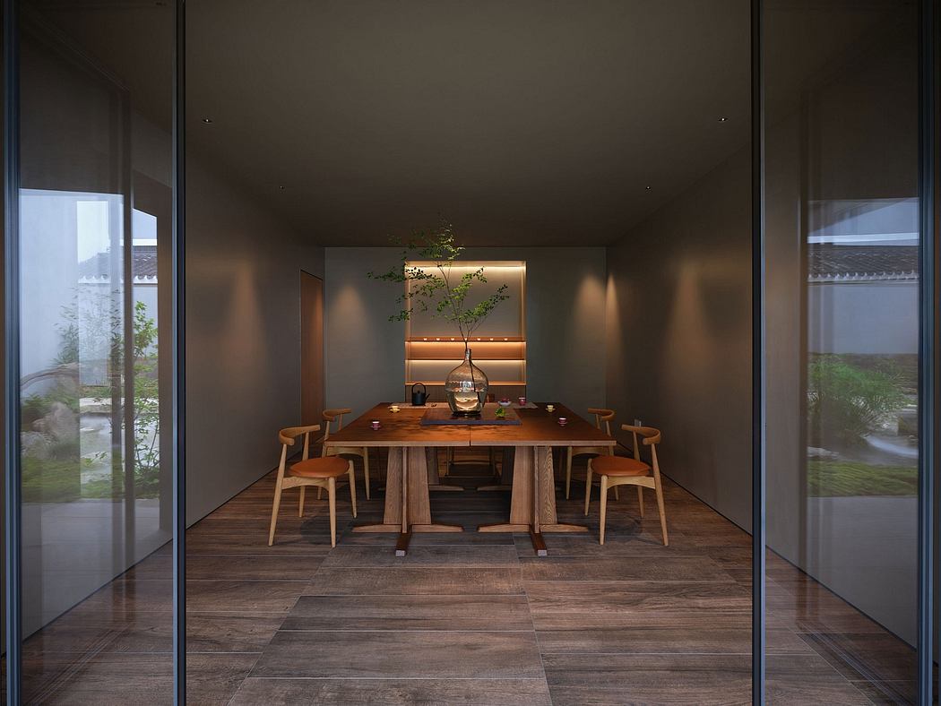 A cozy and minimalist dining room with a wooden table, chairs, and a decorative tree.