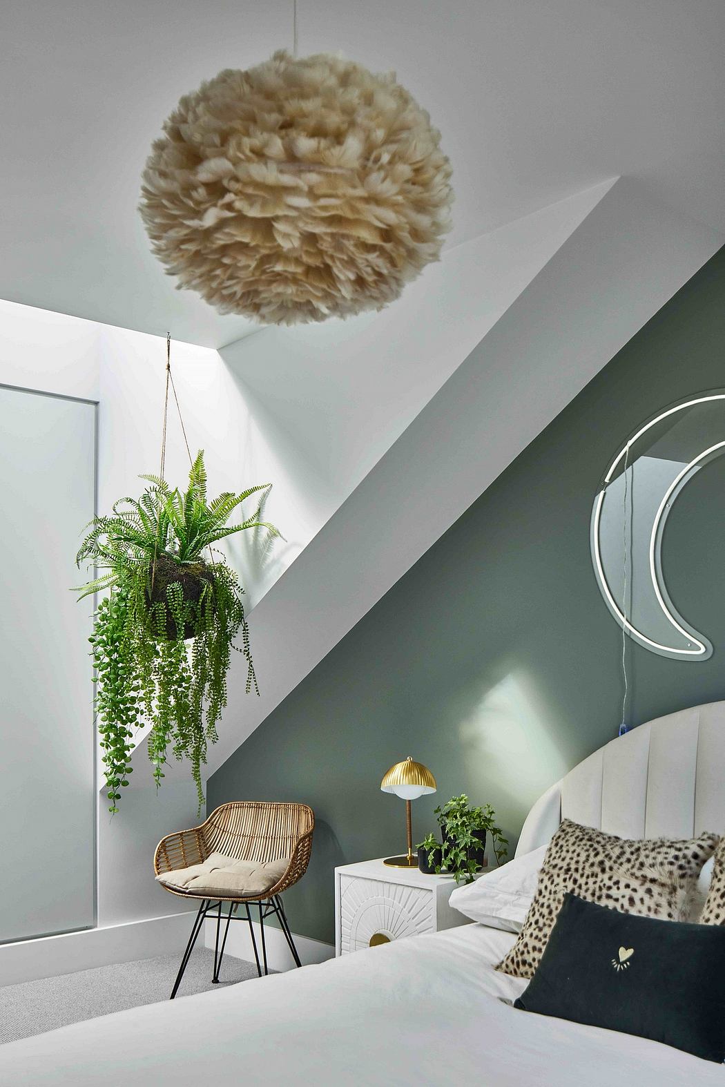 Cozy bedroom with fluffy pendant light, greenery, and retro-inspired furnishings.