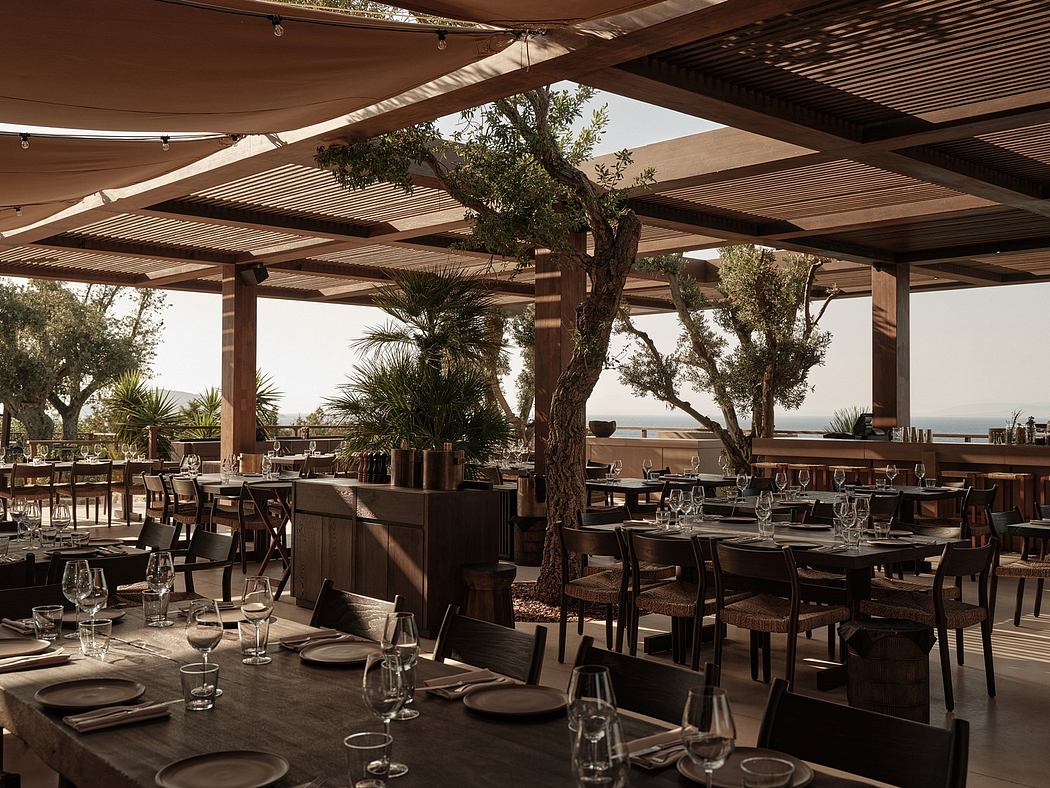 Wooden beams and lush greenery create an inviting outdoor dining space with a tranquil atmosphere.