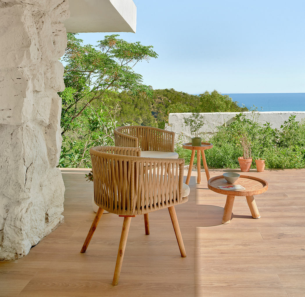 Rustic outdoor seating area with wooden furniture, potted plants, and scenic view.