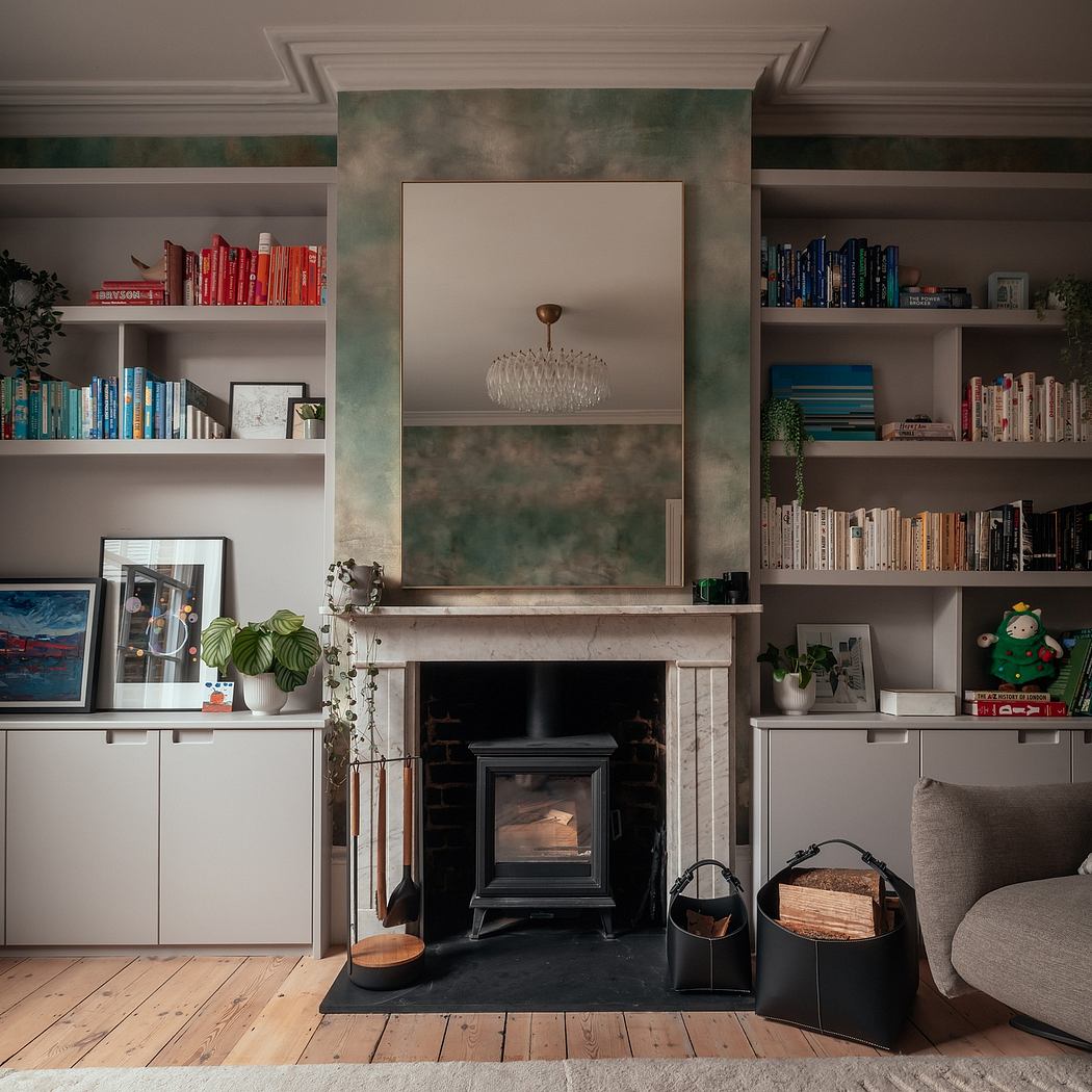 Cozy living room with marble fireplace, built-in bookshelves, and a chandelier.