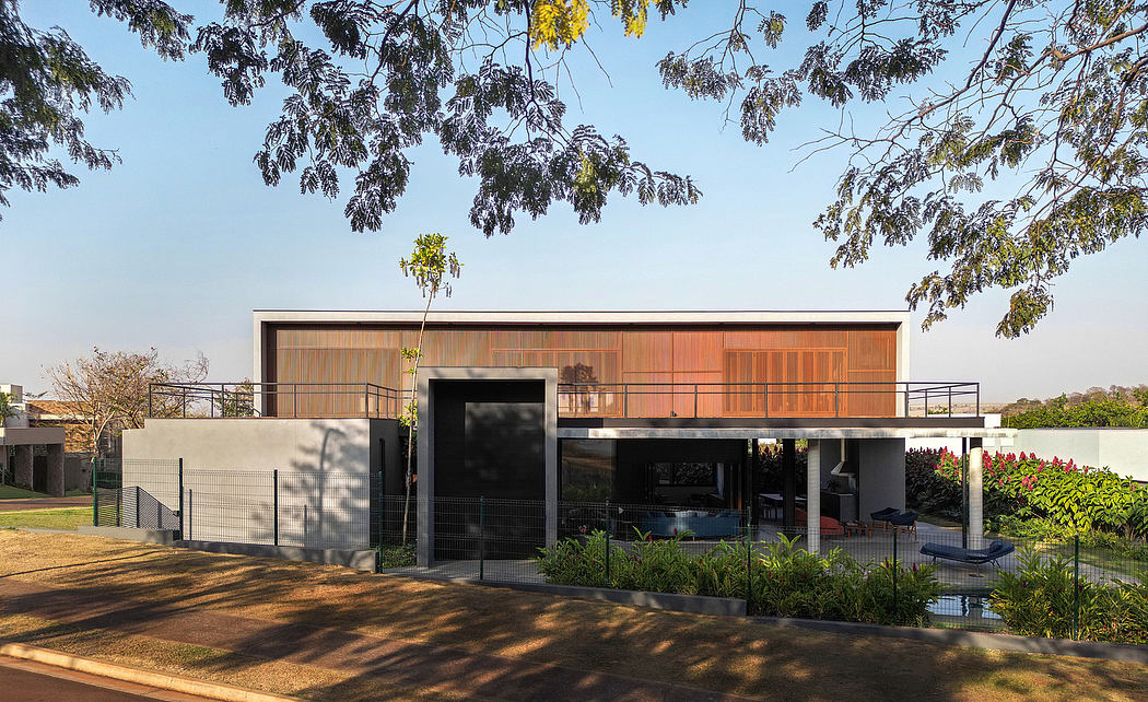 Striking modern building with wooden facade, elevated terrace, and lush landscaping.