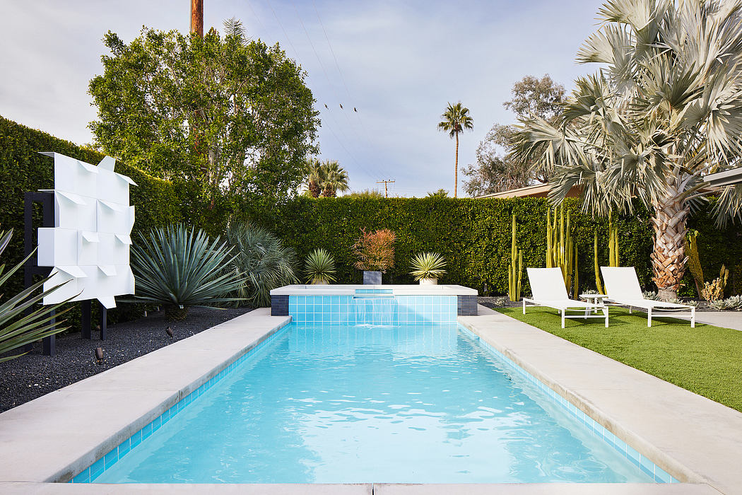 Inviting contemporary pool area with tropical landscaping and modern decor elements.