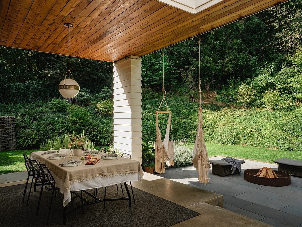 Rustic covered patio with wood-paneled ceiling, hanging lamps, and hammock-style seating.