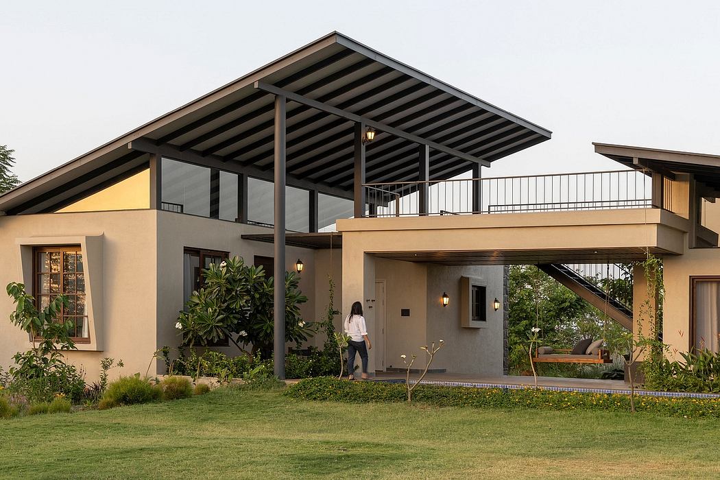 Contemporary two-story home with covered terrace, tropical landscaping, and modern architectural elements.