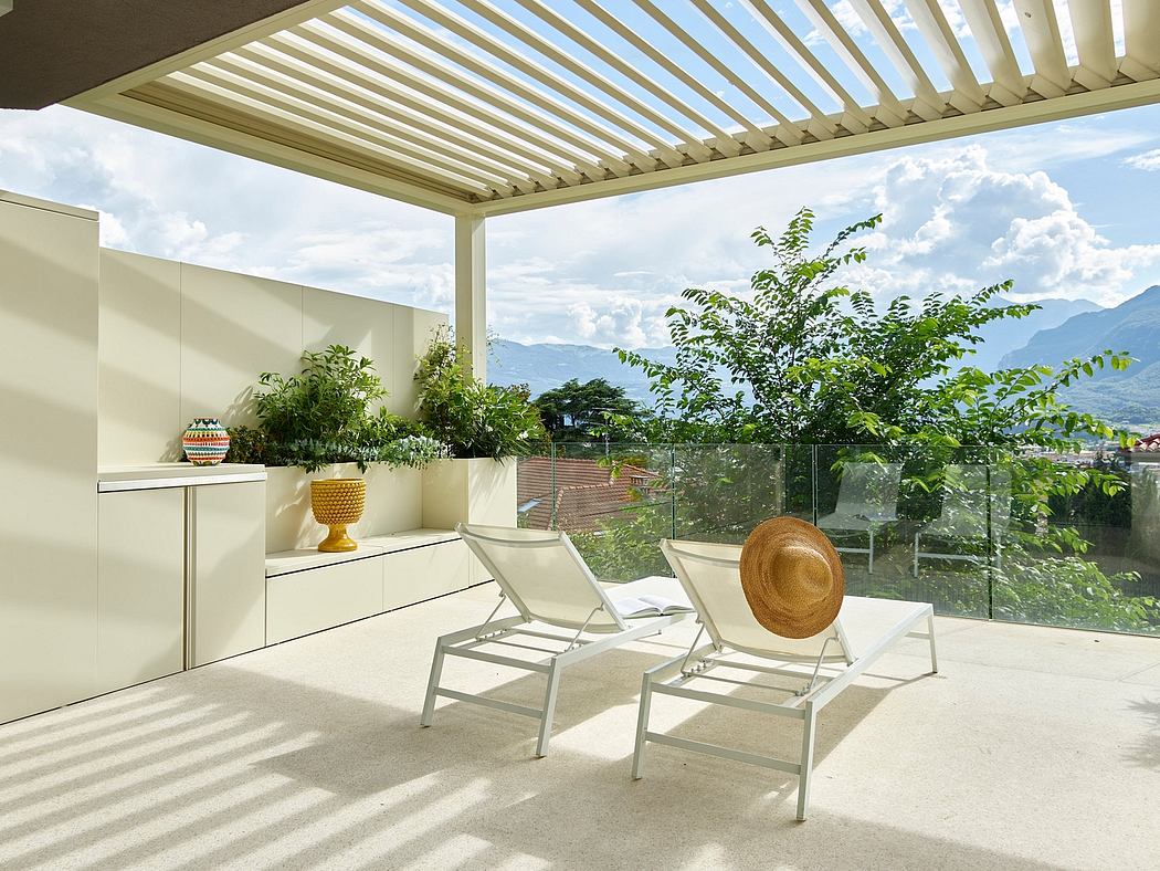 Sunlit pergola with modern furniture, plants, and sweeping mountain view.