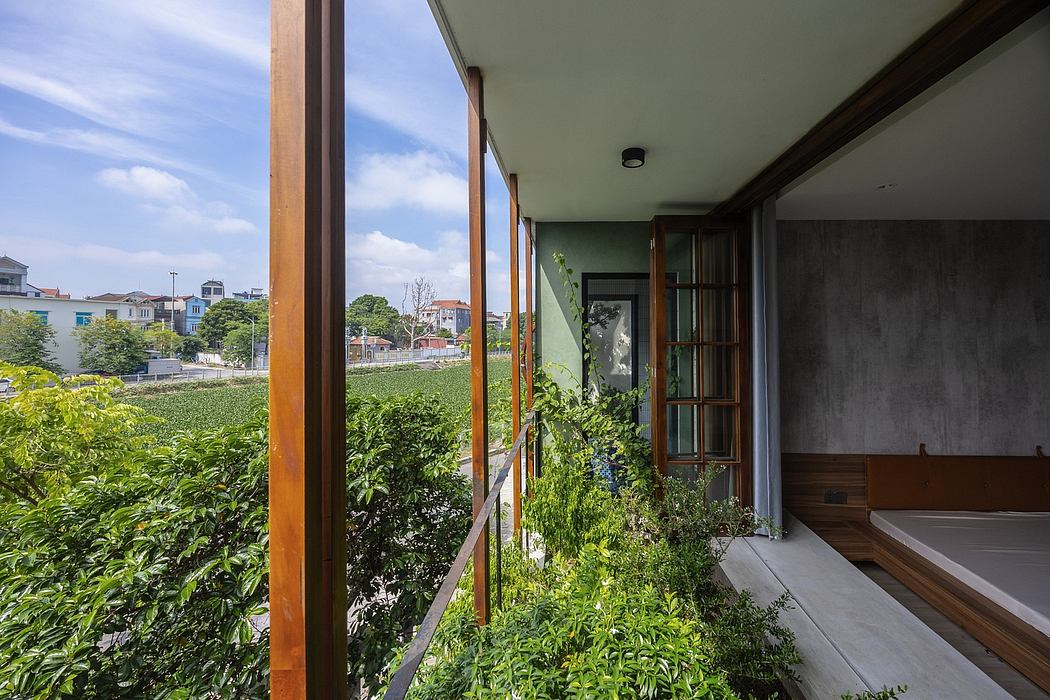 A modern, glass-walled structure blends seamlessly with the lush, surrounding greenery.