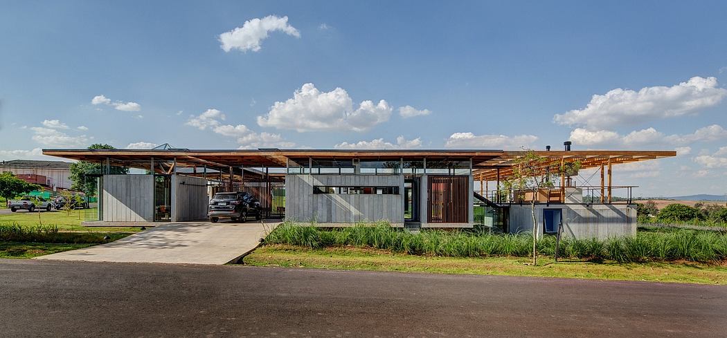 A modern, eco-friendly building with wooden beams, glass walls, and lush landscaping.