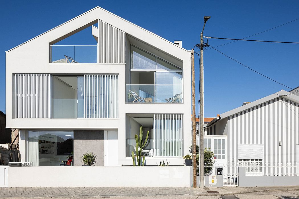 Modern, multi-story building with sleek, angular design, large windows, and contemporary façade.