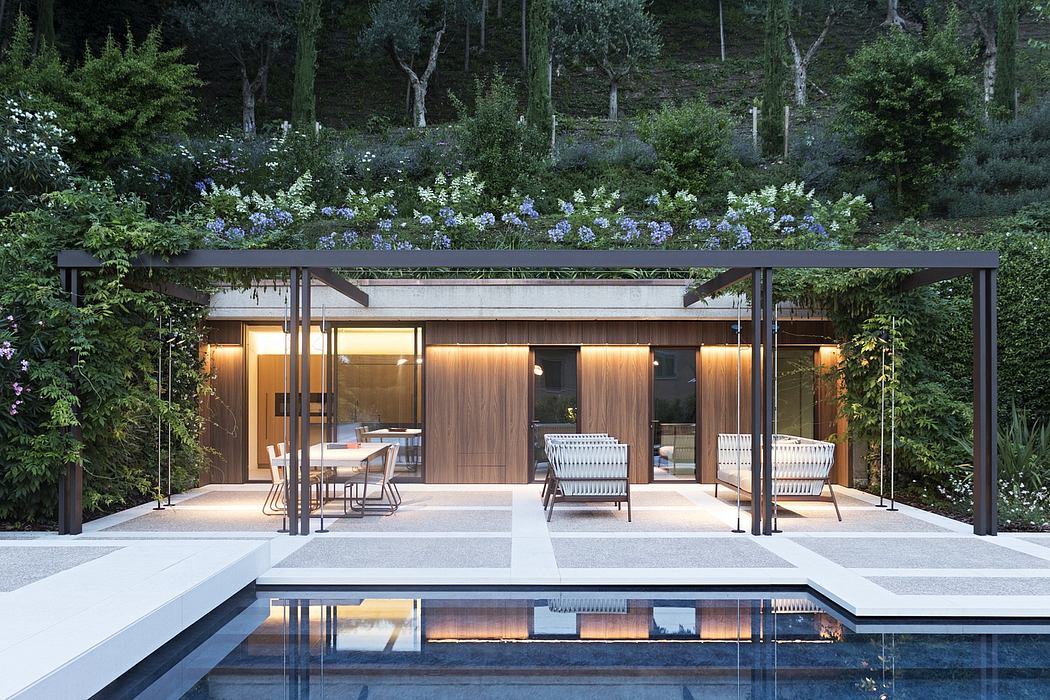 Sleek, minimalist outdoor pavilion with a lush garden setting and reflecting pool.