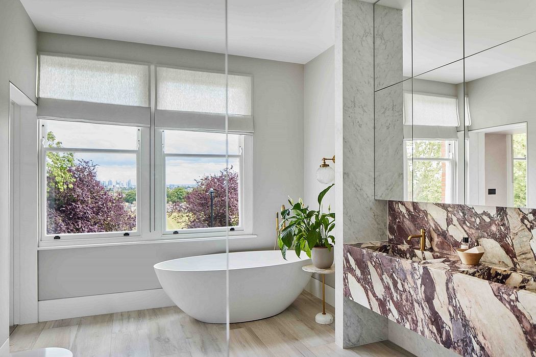 Spacious bathroom with modern freestanding tub, marble vanity, and large windows.