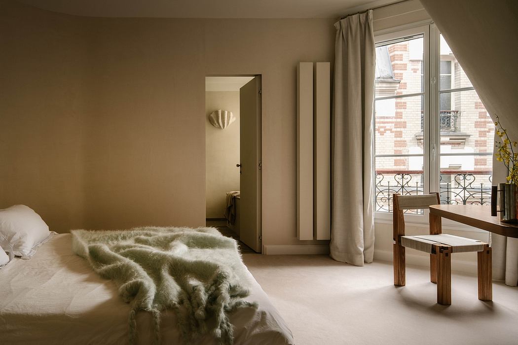Cozy bedroom with brick exterior, wooden furniture, and plush fur blanket.