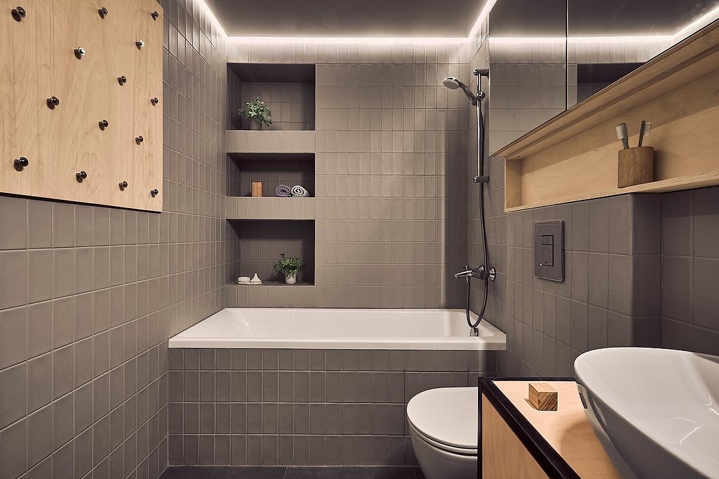 A modern, minimalist bathroom with a tiled tub, shelves, and a sleek toilet design.