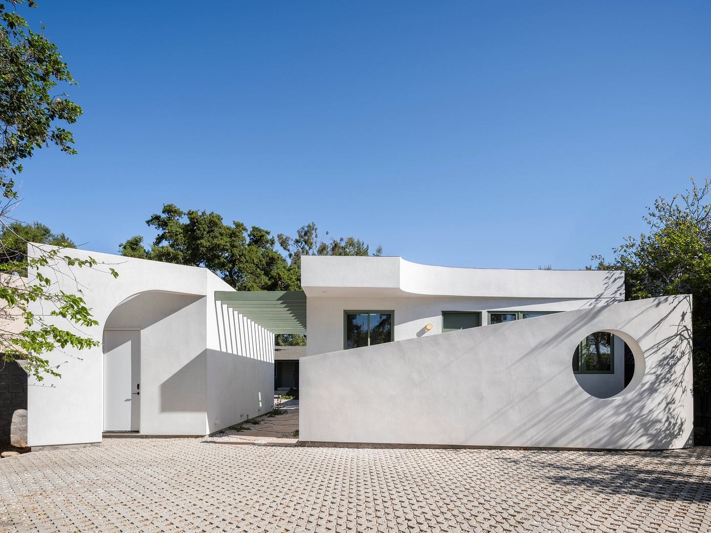 Moon Gate ADU Frames Primary House with Cheerful Geometries