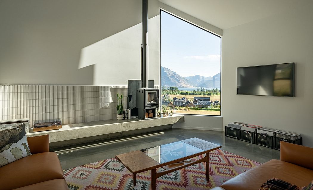 Spacious modern living room with large bay window showcasing mountain landscape.