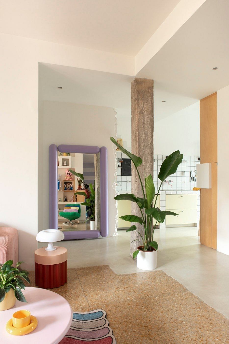 A modern, minimalist interior with a vibrant mix of colors, textures, and natural elements.
