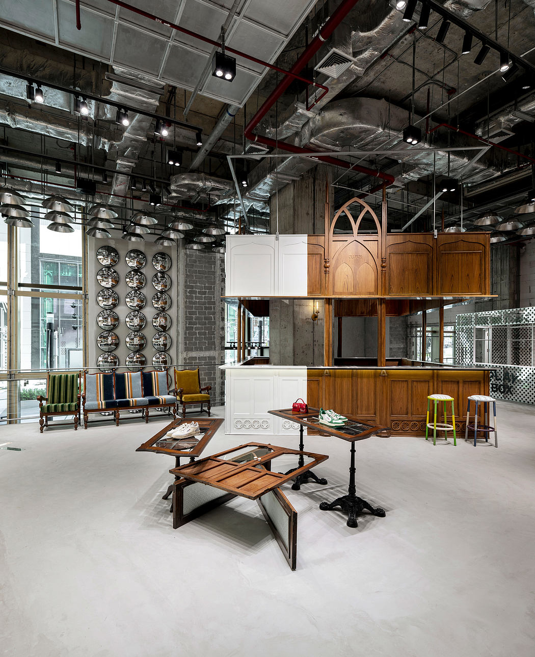 A modern industrial-style space with wooden furnishings, arched cabinetry, and hanging lights.