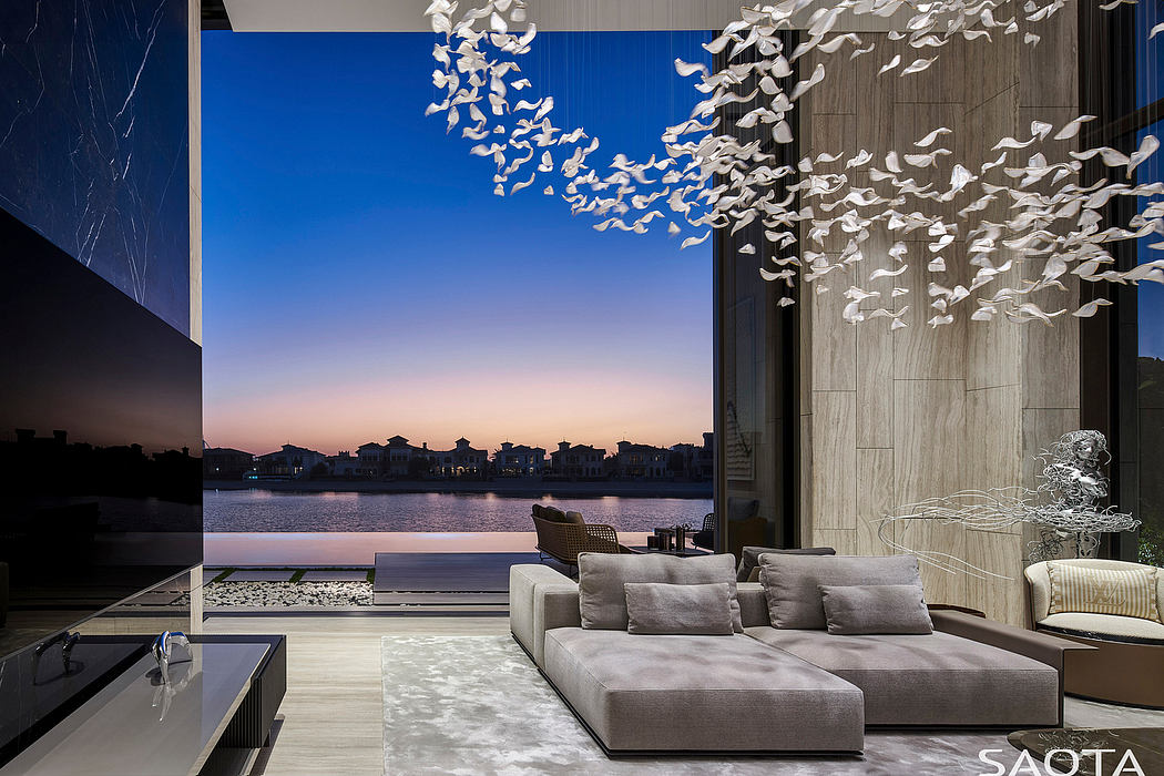 Stunning modern living room overlooking a lake, with a striking sculptural light fixture.