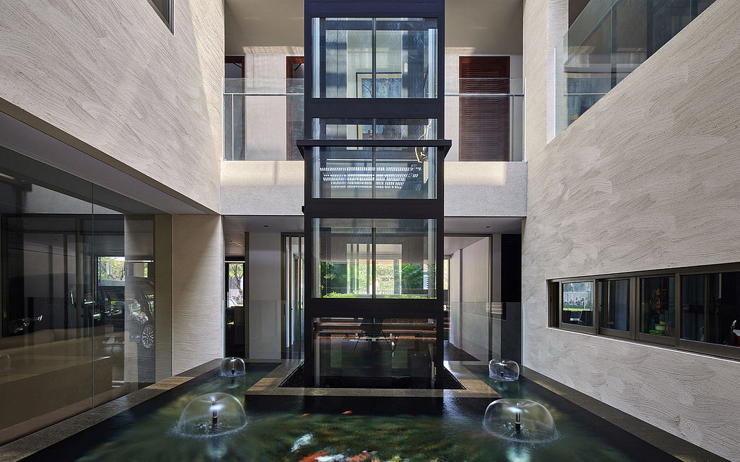 Striking contemporary interior with glass-enclosed central water feature.
