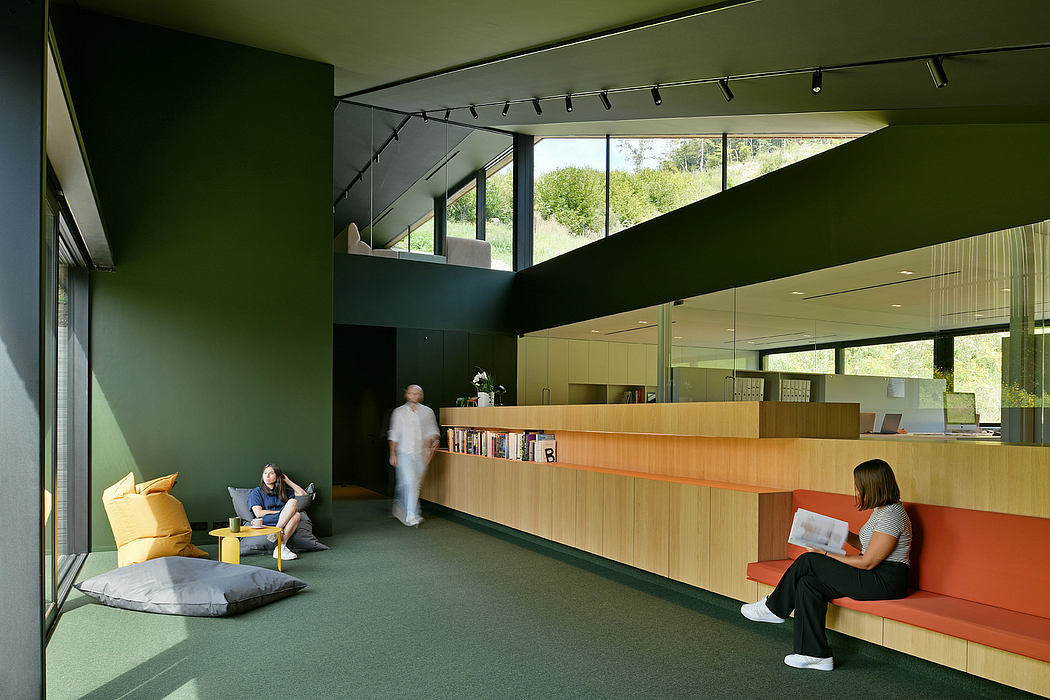 Vibrant green interior with wood accents, seating, and overhead lighting.