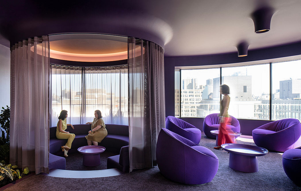 Vibrant purple seating arrangements with curved walls and large windows offering city views.