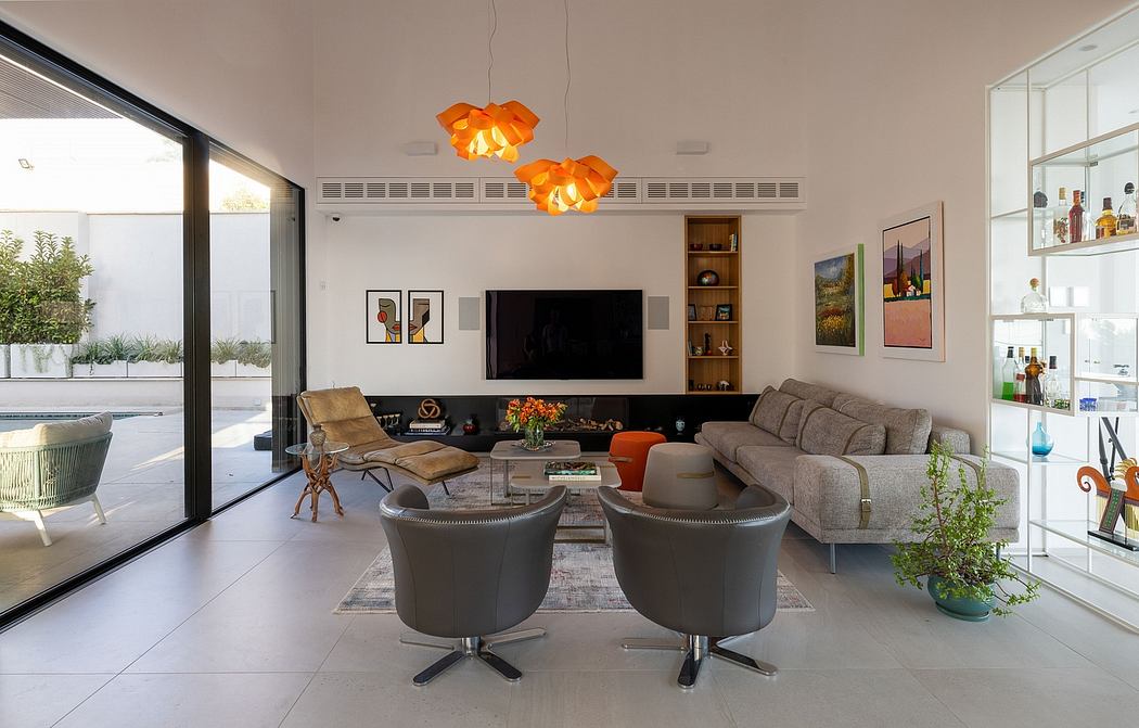 A modern, open-concept living room with sleek furniture, vibrant lighting, and a large TV.