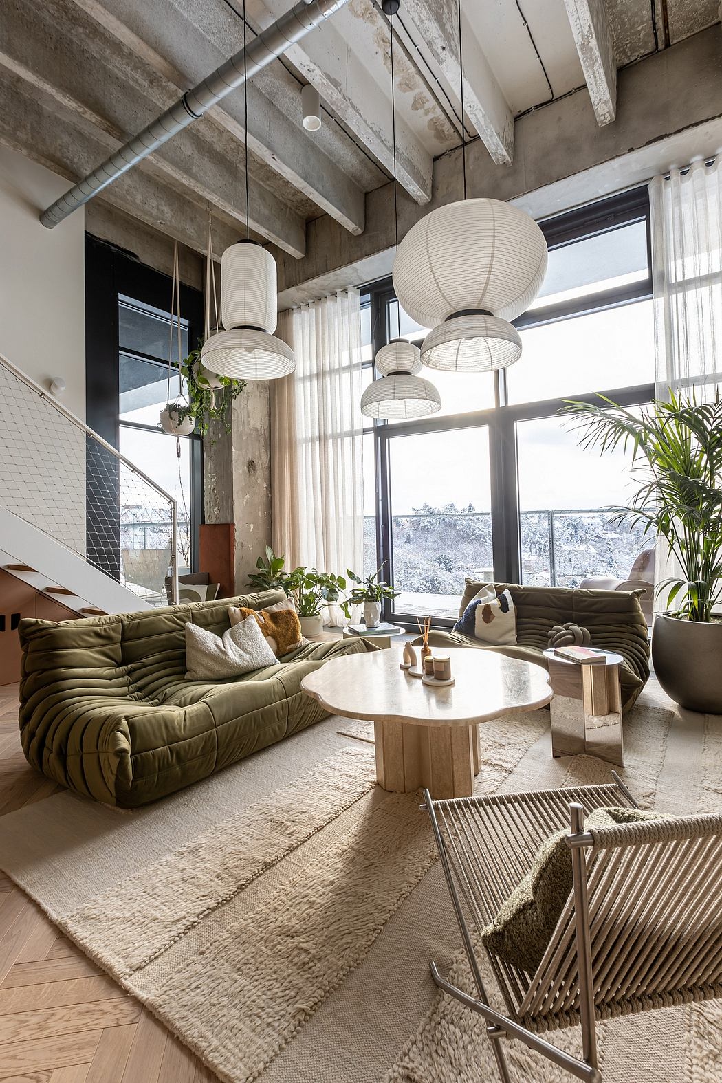 Cozy, modern living space with exposed beams, recessed lighting, and plush seating.