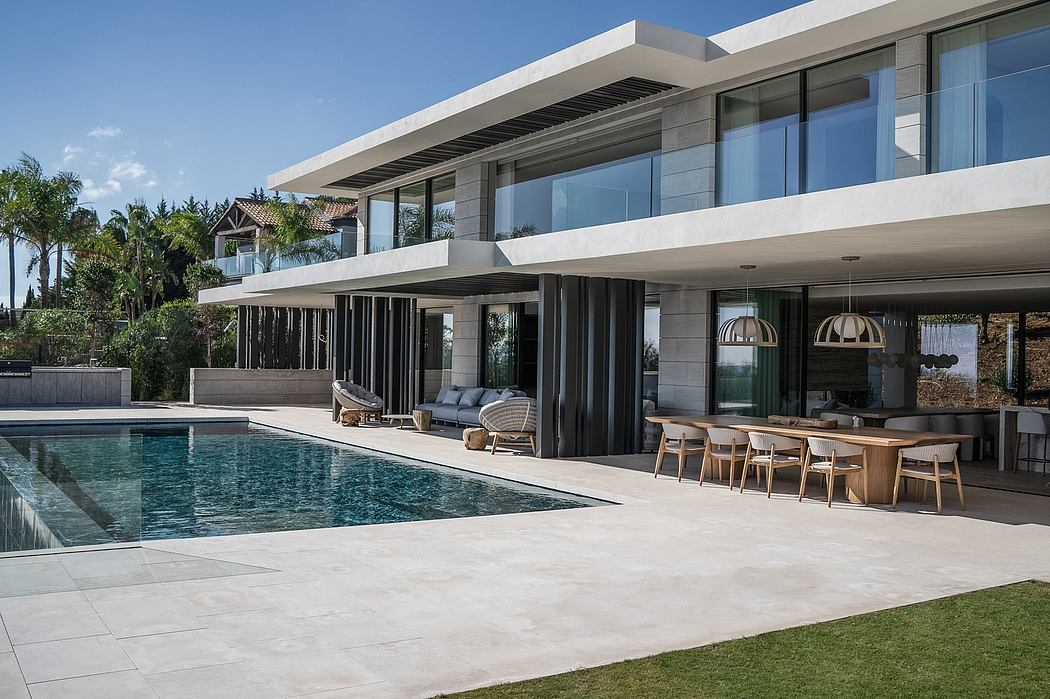 A modern, sleek outdoor living area with a pool, lounge furniture, and covered dining space.