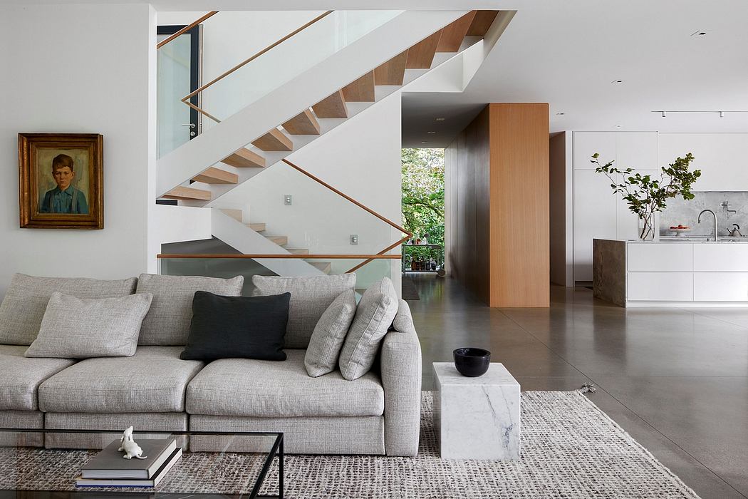 Sleek minimalist interior featuring an open-plan layout, modern staircase, and neutral color palette.