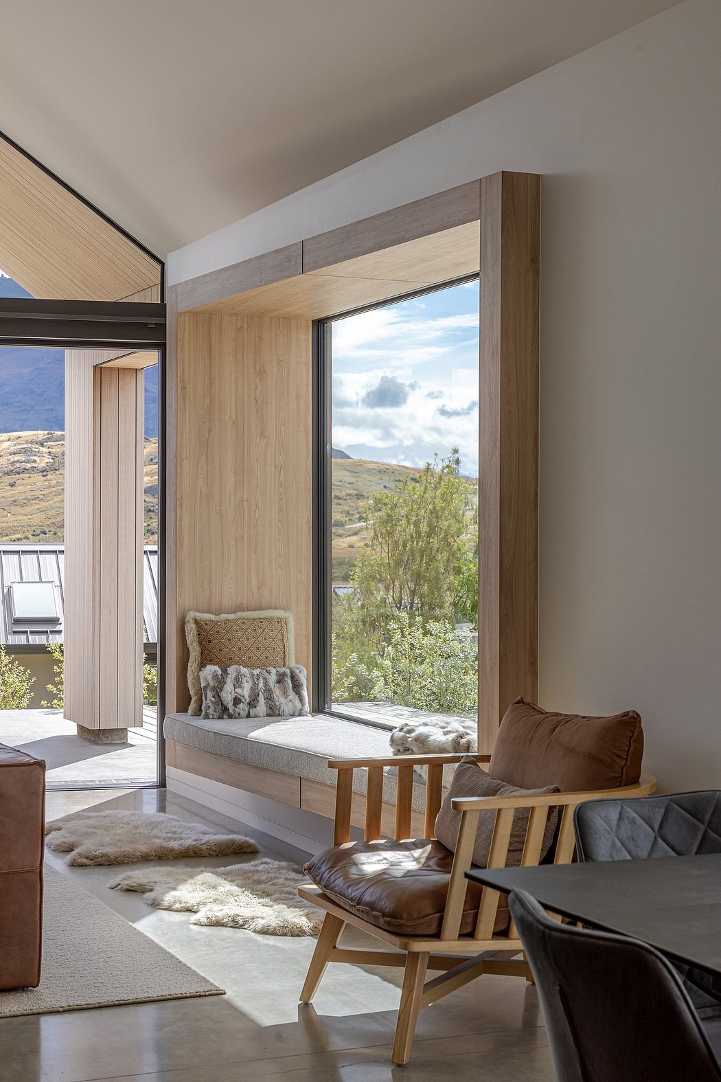 A modern, cozy interior with wooden accents and a breathtaking mountain view.
