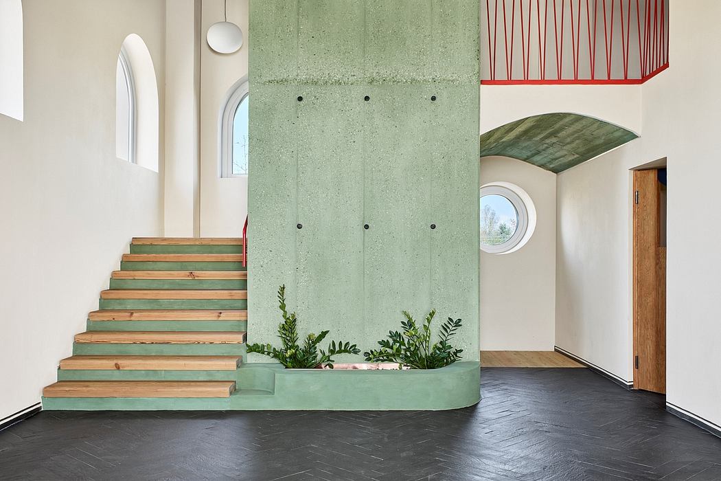 Minimalist interior with green concrete wall, wooden stairs, and various architectural elements.