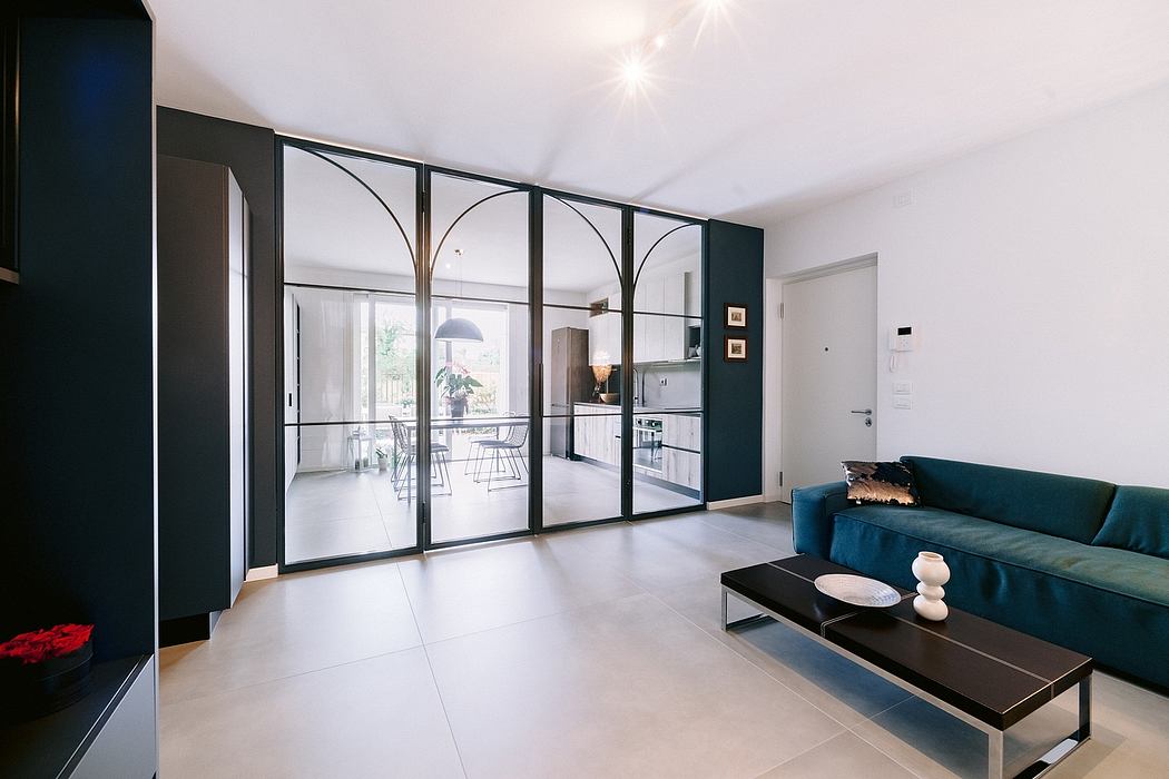 Spacious modern living room with sleek black-framed glass walls, open floor plan.