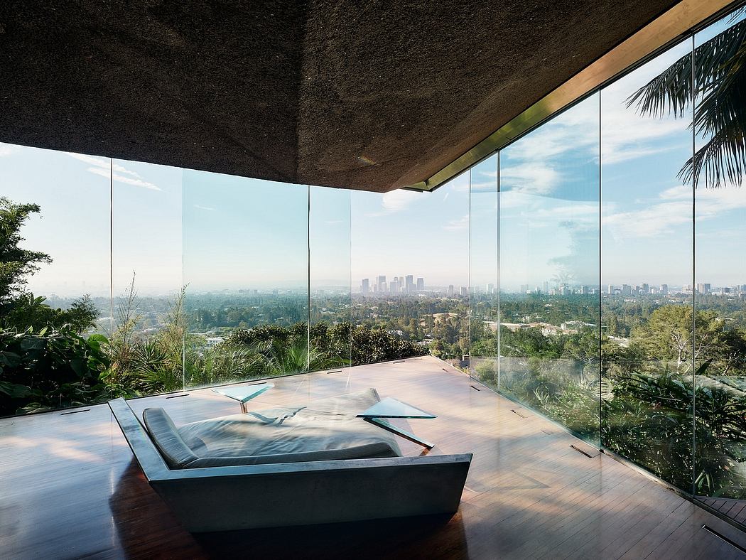 Stunning glass walls showcase a breathtaking city skyline view amidst lush tropical foliage.