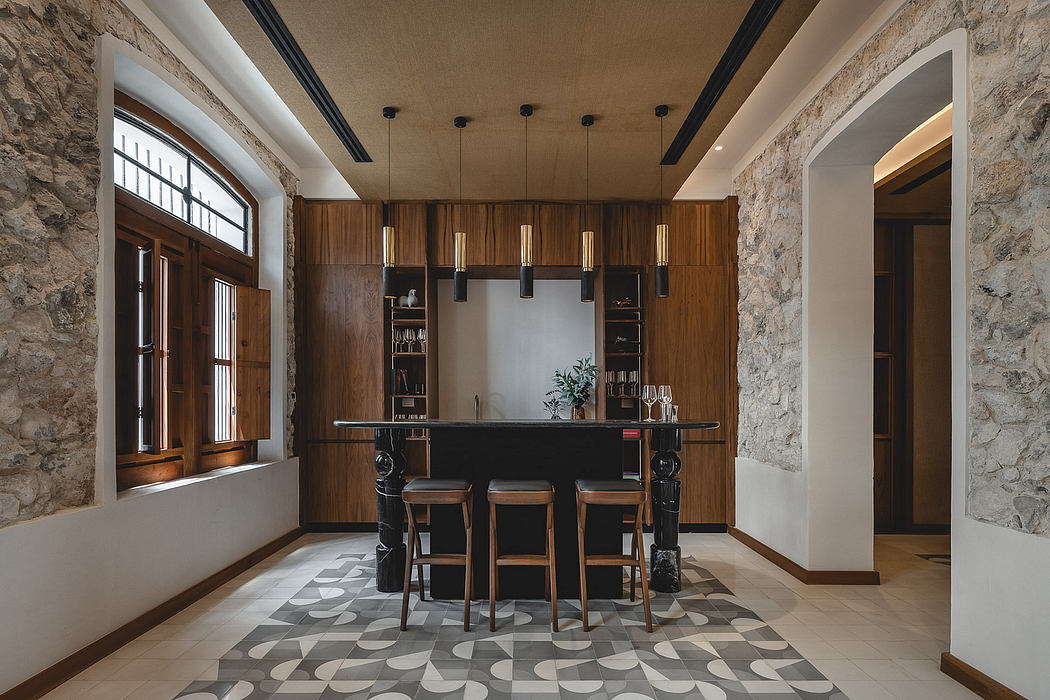 A rustic, modern interior with a stone accent wall, wood cabinetry, and geometric tile flooring.