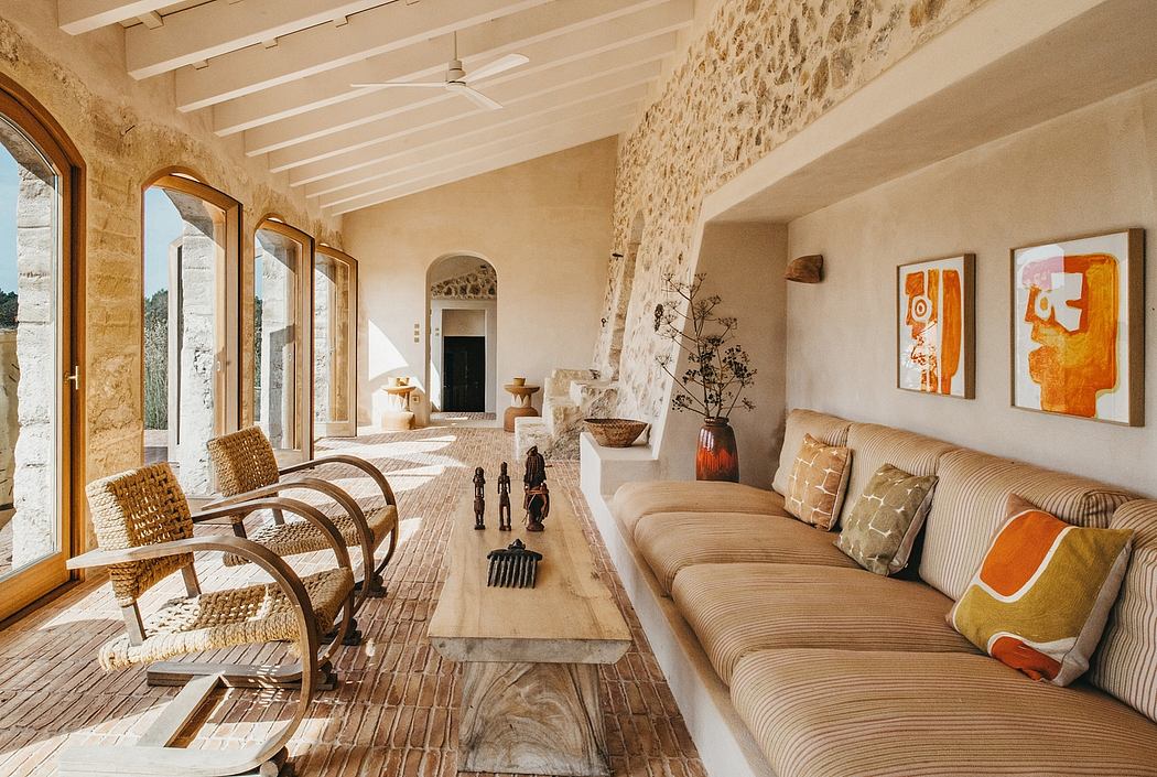 Spacious Mediterranean-style interior with stone walls, wooden beams, and modern furnishings.