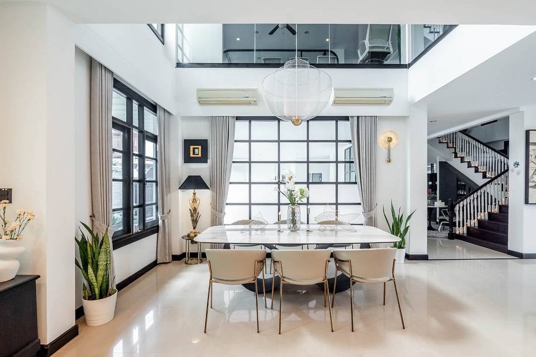 Spacious dining area with modern furnishings, large windows, and sleek architectural elements.