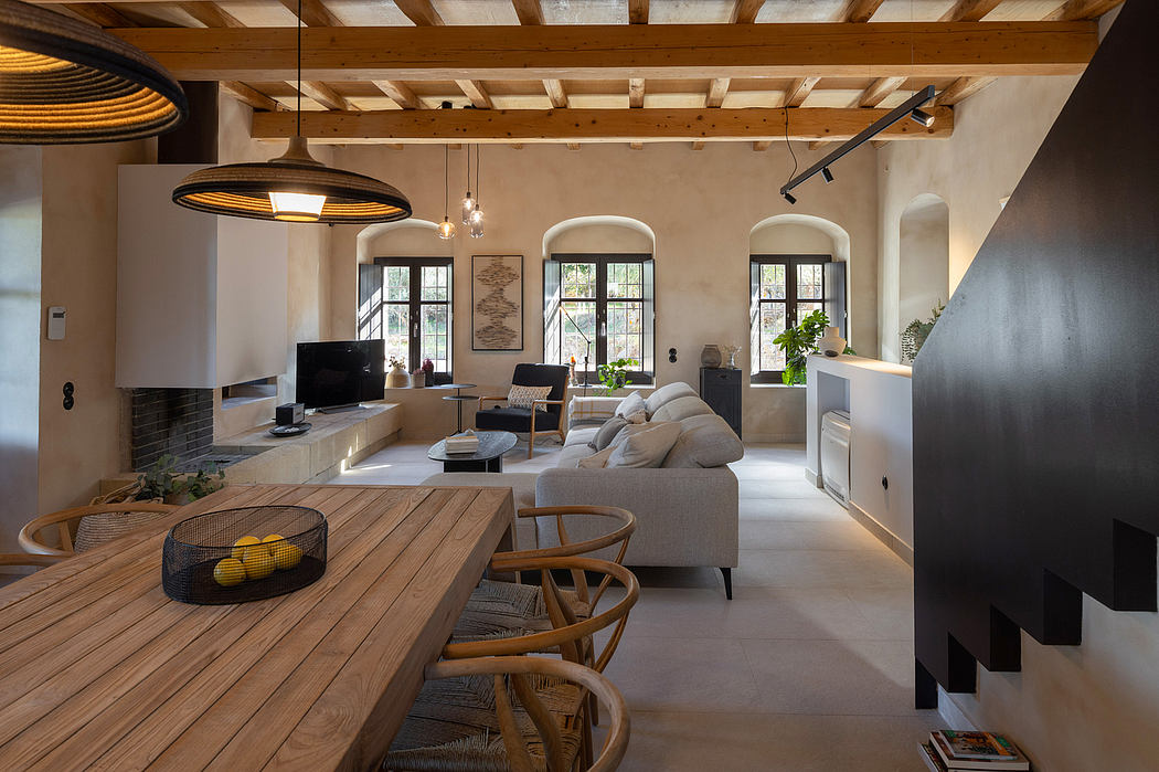 Rustic wooden beams, modern lighting, and sleek furnishings create a cozy, inviting space.