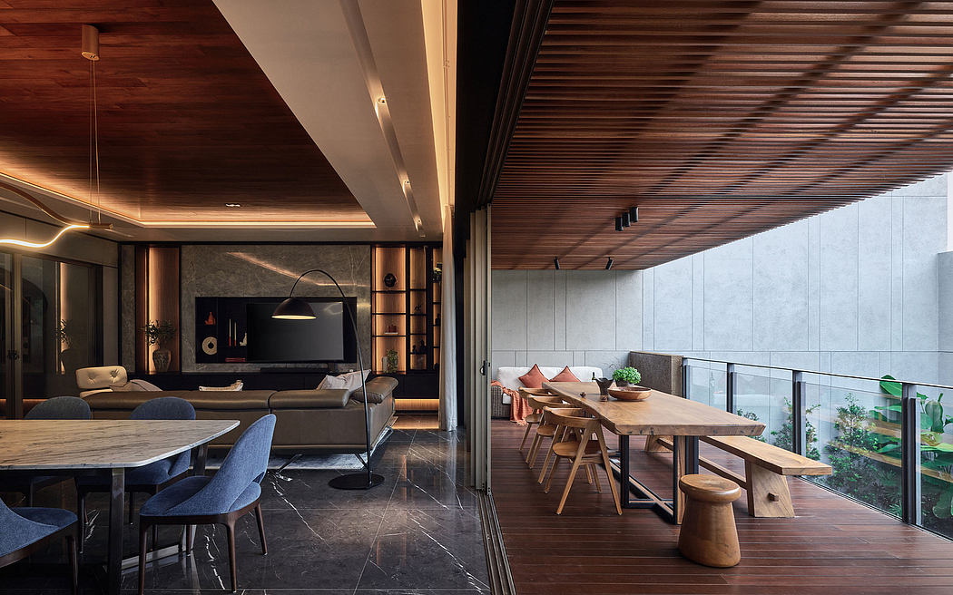 Modern open-plan living and dining space with wooden ceiling, large glass windows, and sleek furnishings.