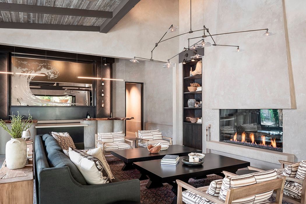 Cozy modern living room with fireplace, exposed beams, and statement lighting.