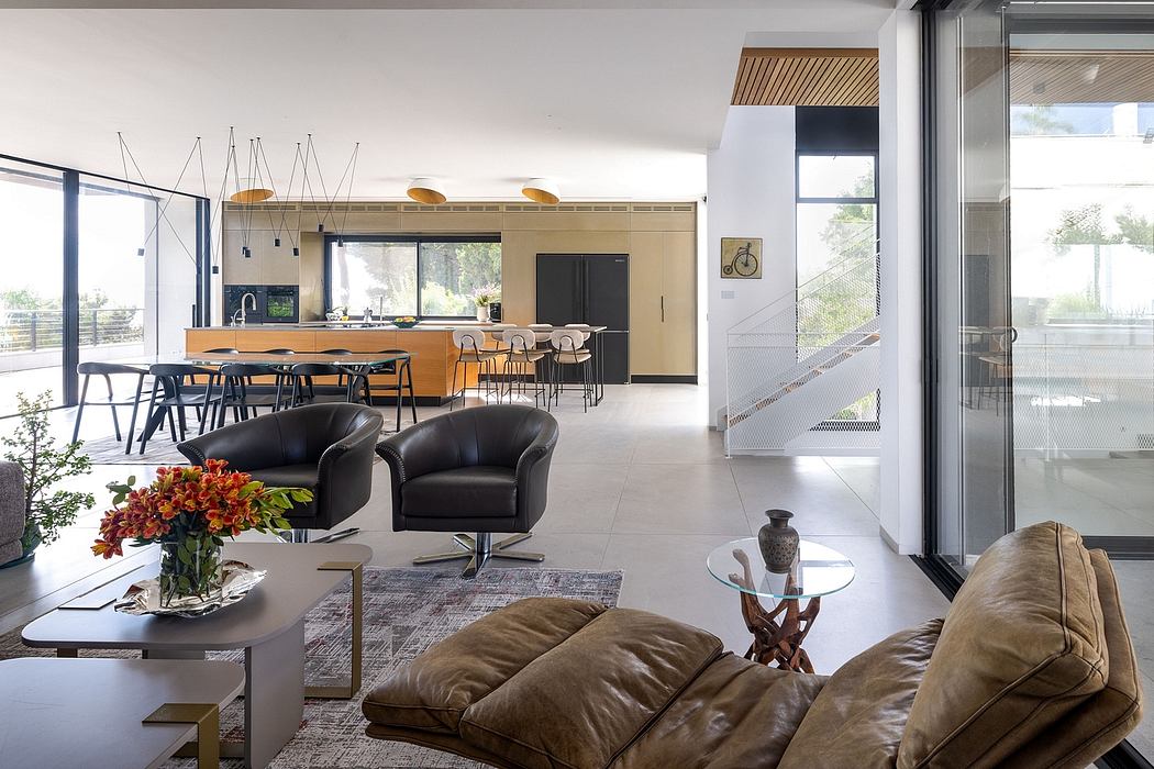 Open-concept modern home with sleek kitchen, dining, and living area. Minimalist design with warm wood and glass accents.