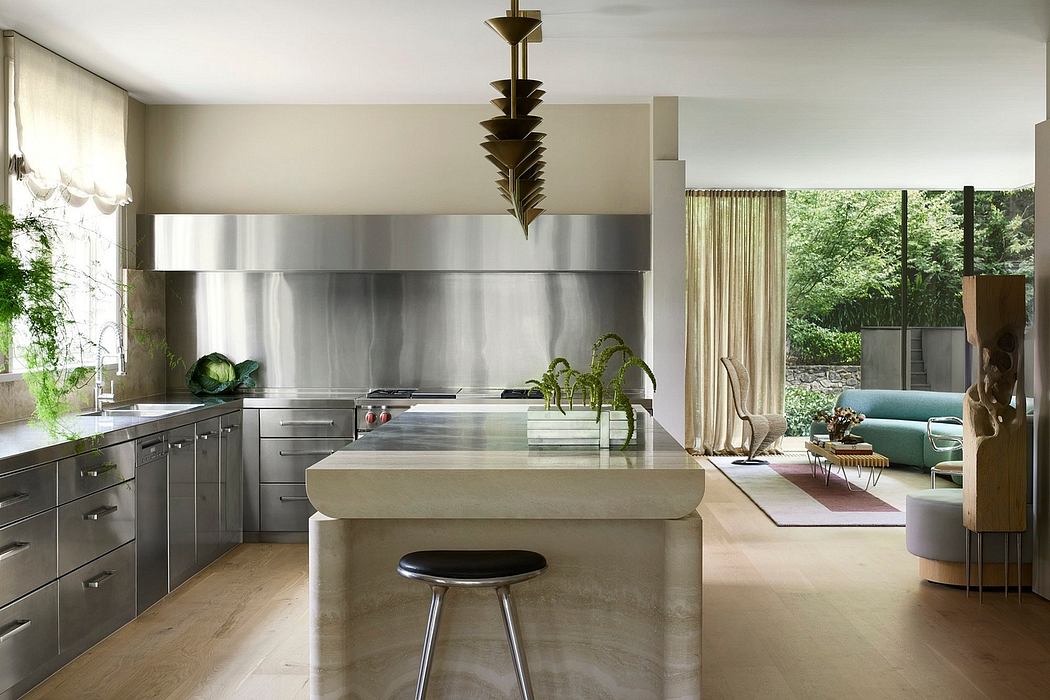 A modern, open-concept kitchen featuring stainless steel appliances, a large island, and a statement light fixture.
