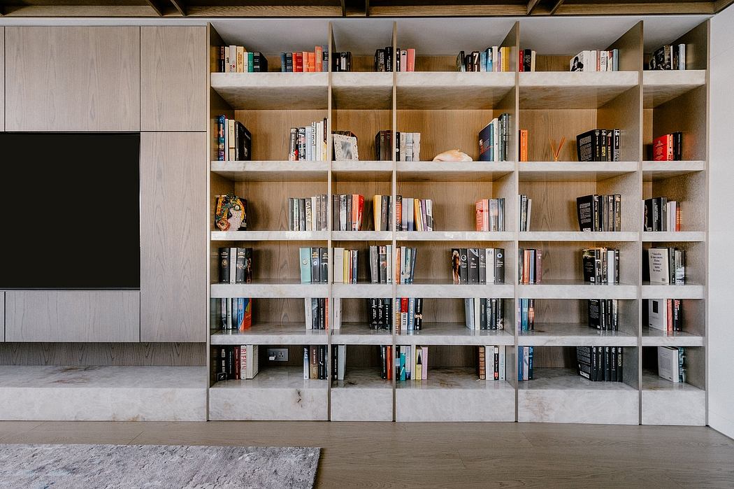 Extensive built-in cabinetry and shelving system with organized book storage in a modern interior.