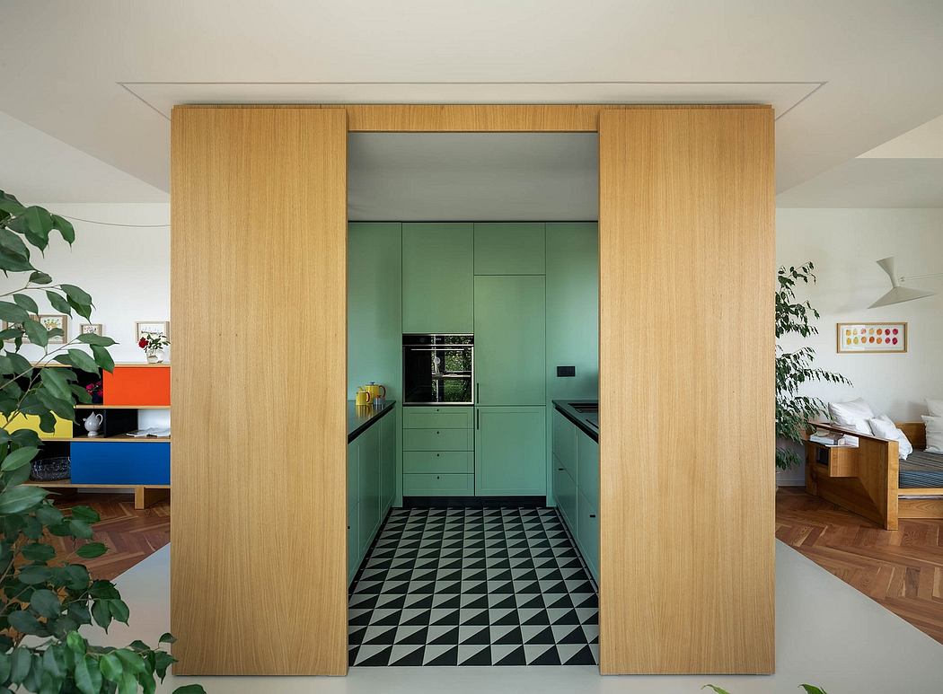 Sleek, minimalist kitchen design with wooden paneling and vibrant green cabinetry.