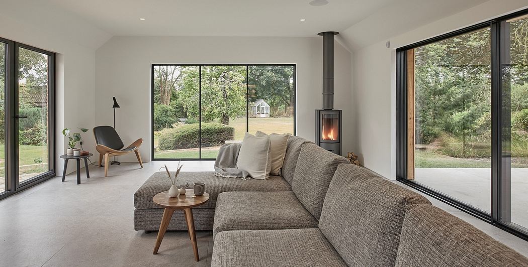 Spacious living room with expansive windows, cozy sectional, and modern fireplace.