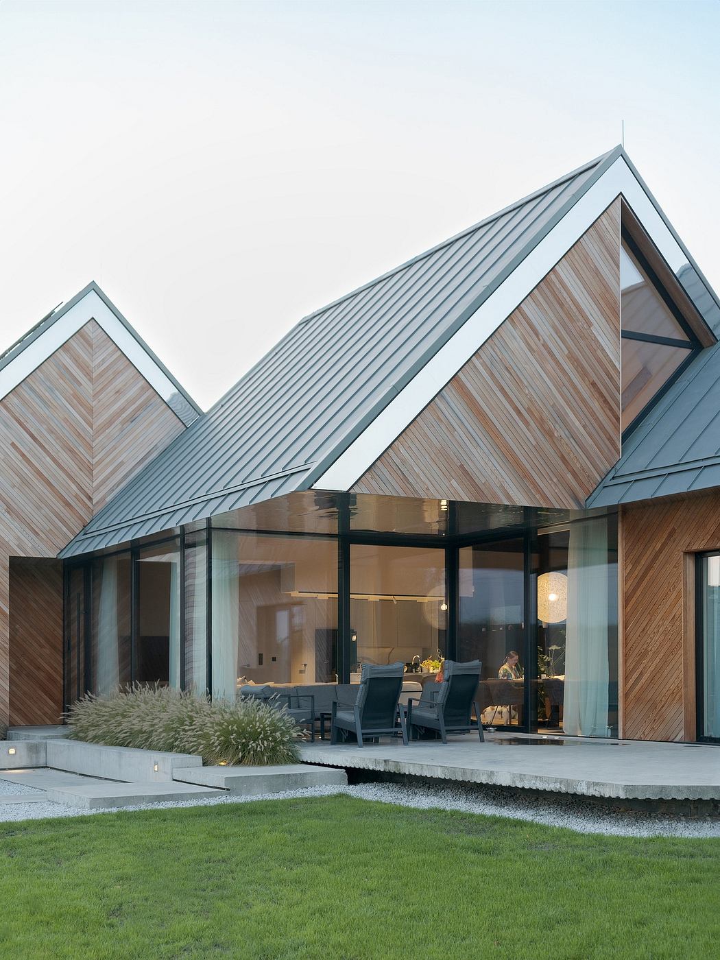 A modern architectural masterpiece with sleek wooden exterior and striking angled roof.