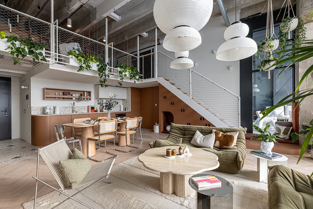Spacious open-concept living area with hanging plants, white globe lights, and a modern kitchen.