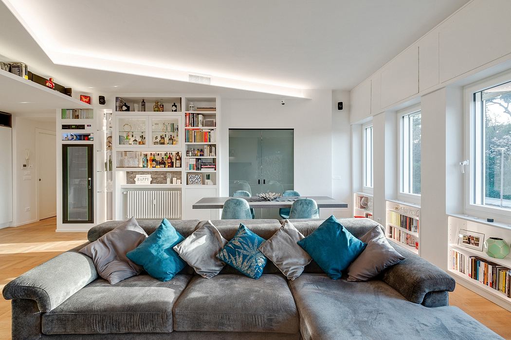 Stylish open-plan living room with built-in shelving, comfortable sofa, and modern decor.