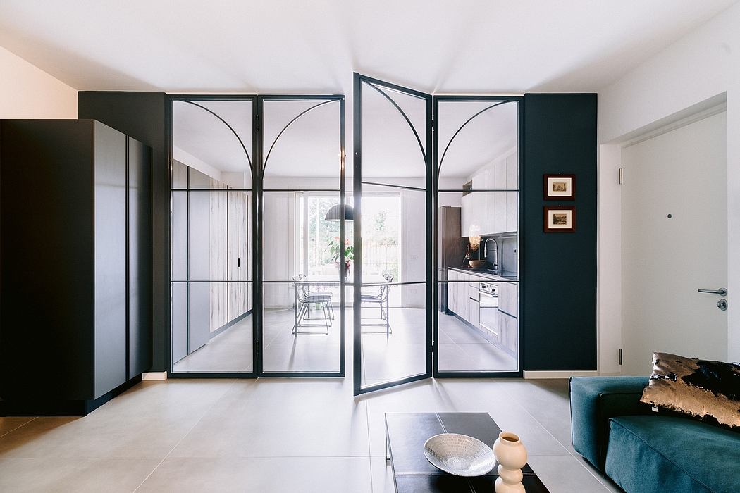 Sleek, modern glass doors and windows frame the open-concept kitchen and living area.
